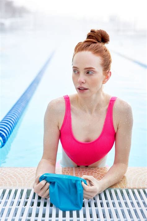Pretty Awesome Ginger Woman Putting On Swim Cap At The Pool Stock Image Image Of Swimwear
