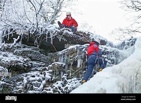 Two Climbers At The End Of An Ice Climb On A Frozen Waterfall Lynn Falls Outside Dalry In