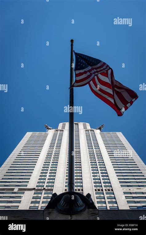 The American Flag Waving In The Foreground Looking Up On The Chrysler