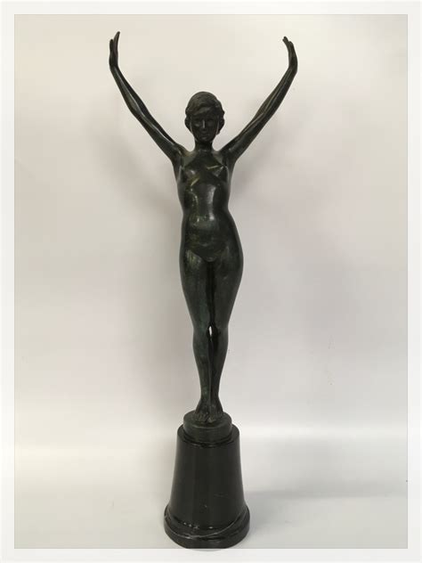 an art deco patinated bronze of a nude female dancer mounted on black marble base 52cm overall