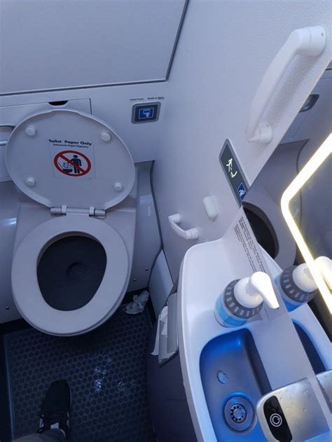 An Airplane Bathroom With A Toilet And Sink