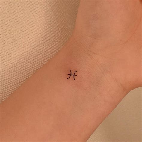 Minimalist Pisces Zodiac Symbol Tattoo On The Wrist