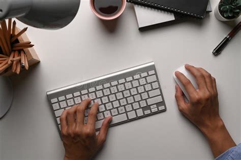 Above View Of Man Hand Typing On Keyboard And Holding Mouse On White