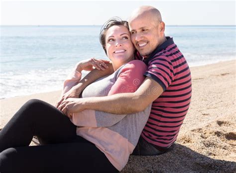 Elderly Man With A Woman Sitting On Sand On Beach Stock Image Image Of Bald Lovers 77852167