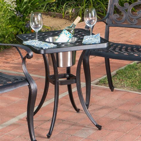 An Outdoor Table With Two Wine Glasses On It