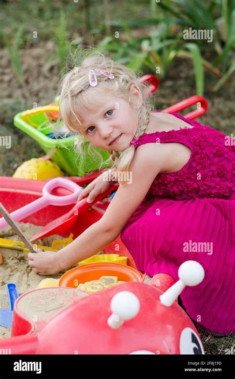 Little Blond Girl Playing In Sandpit On The Playground Stock Photo Alamy