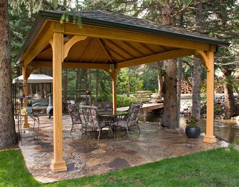 A Wooden Gazebo Sitting On Top Of A Lush Green Field