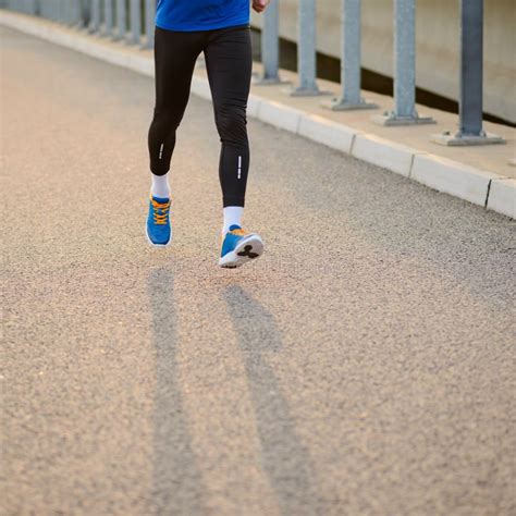 Close Up Of Male Sports Mans Legs Running At Sunset Healthy Lifestyle And Sport Concept Stock