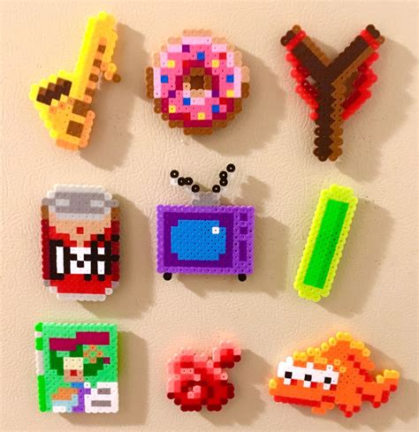 Pixel Art Magnets Are Displayed On A Wall In The Shape Of Donuts