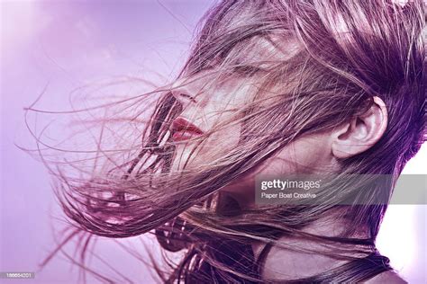 Brunette Woman With Hair Sweeping Over Her Face Photo Getty Images