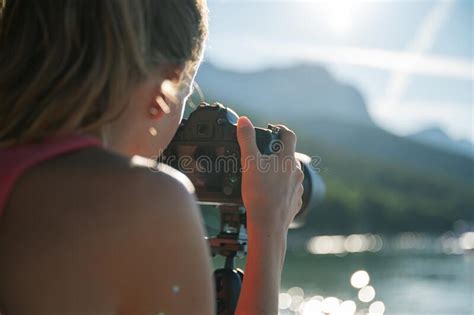Young Female Photographer Taking Photos Of Beautiful Summer Nature By