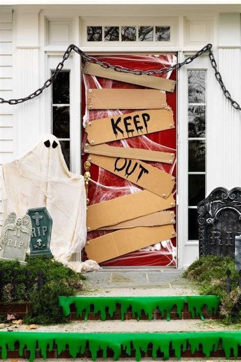 A Door Decorated With Halloween Decorations And Paper Cut Out To Look