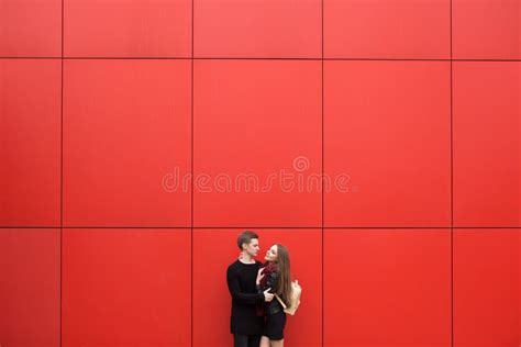 Young Couple In Black Clothes Posing With A Background On The White