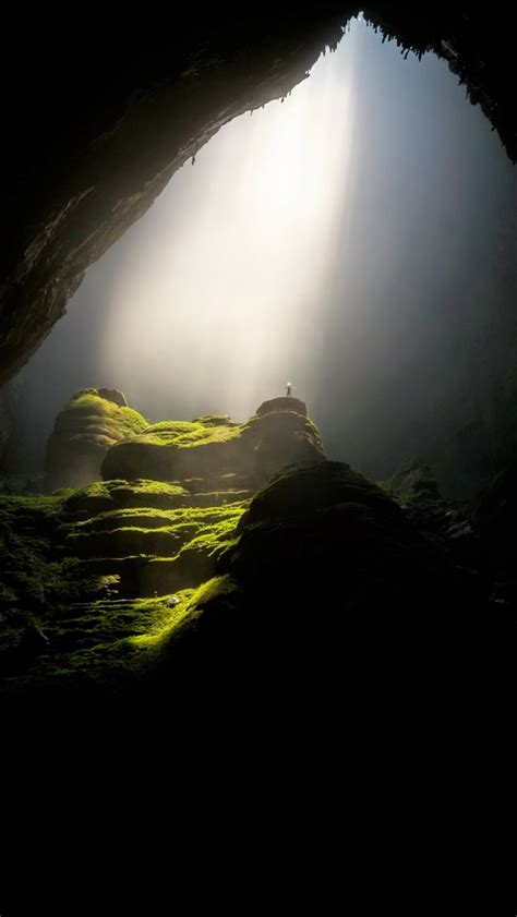 Person On Top Of Rock Formation Inside Cave Iphone Wallpapers Free Download