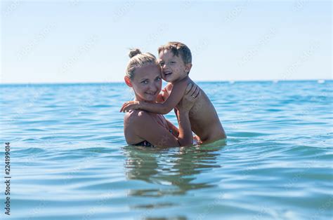 Mother And Son Playing On The Beach In The Day Time Portrait Of Happy