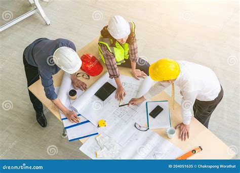 Team Of Engineers And Architects Working Planing Measuring Layout Of