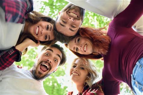 Friends In Circle With Heads Together Smiling Photo Free Download
