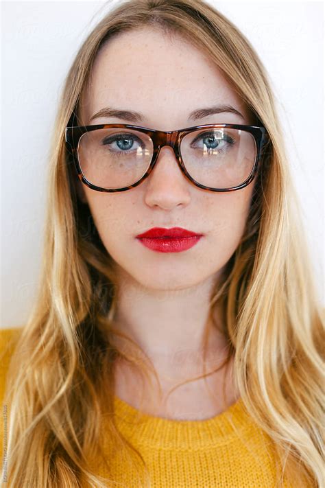 Closeup Portrait Of A Blonde Woman Wearing Rimmed Glasses By