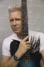 U2 Bass Guitarist Adam Clayton Strums Funky Blue Guitar, Color from ...