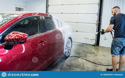 Worker Washing Car With Active Foam On A Car Wash Stock Photo Image