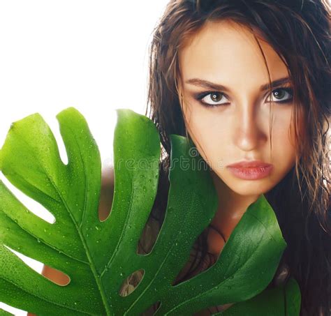 Young Pretty Brunette Woman With Big Green Leaf On White Background