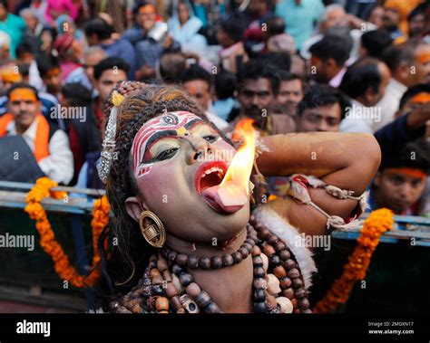 A Man Dressed As Hindu God Shiva Performs A Fire Act During A