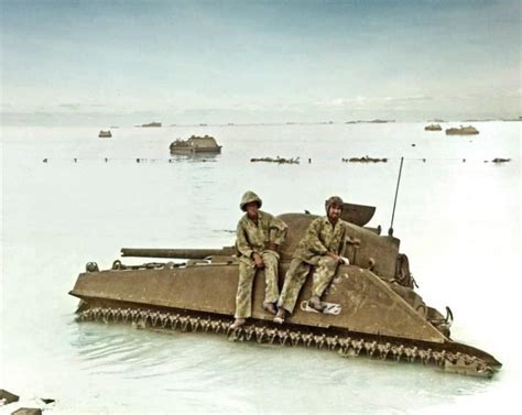 Two Marines Sit Atop The M4a2 Sherman “cecilia” Who Provided Red Beach