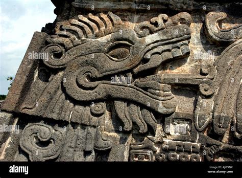 Ancient stone serpent deity carving/sculpture on a Mayan pyramid at