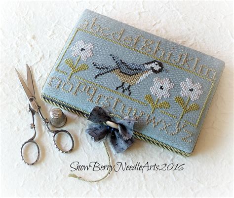 A Beautiful Cross Stitched Needle Book To Decoratively Hold Sewing And