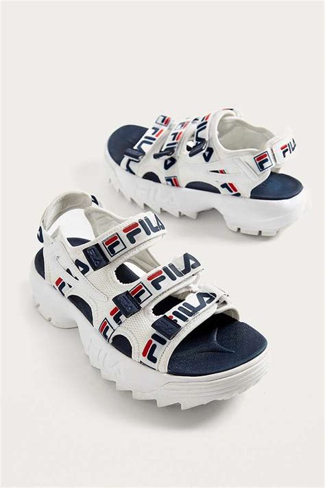 Nostalgic style and throwback vibes, comfortable, durable and great looking, this athletic shoe is a new twist on an old favorite. FILA Disruptor Logo Sandals | Urban Outfitters UK