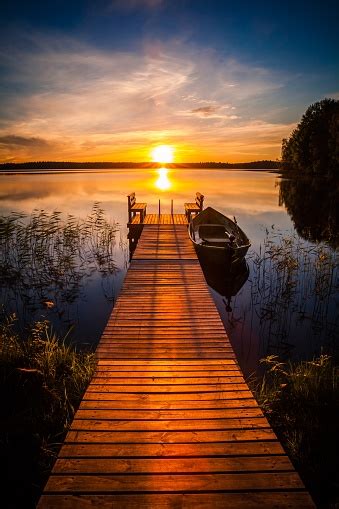 Sunset Over The Fishing Pier At The Lake In Finland Stock