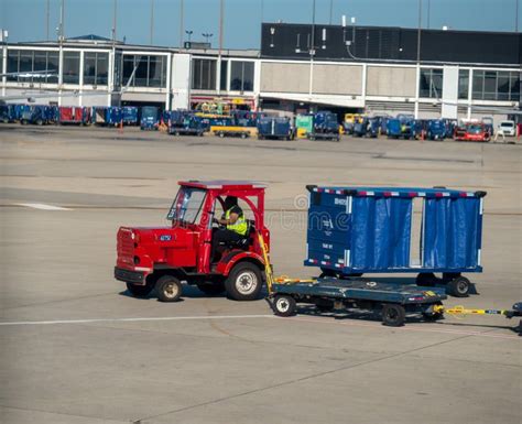 Man Drives Luggage Truck On Airport Runway Near Terminal Editorial
