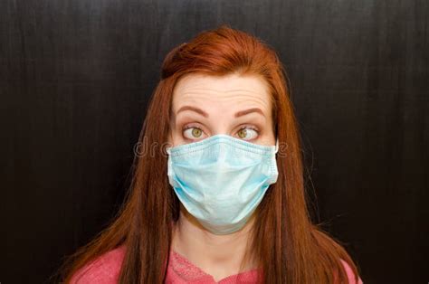 Young Crazy Tired Redhaired Girl With Beveled Eyes In Blue Mask Pink