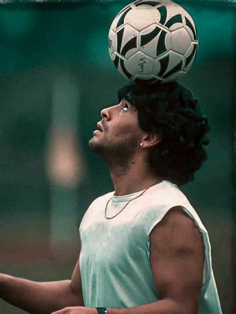A Man Balancing A Soccer Ball On His Head