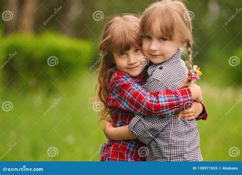 Two Girls Hugging Each Other On Green Stock Image Image Of Happy
