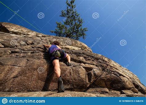 Rock Climber Is Climbing Up A Cliff Stock Image Image Of Landscape