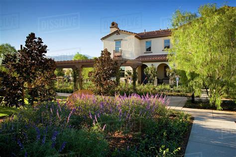 Exterior Contemporary Spanish Style Home With Lush Gardens Stock