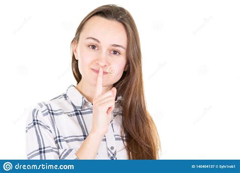 Closeup Of A Beautiful Young Woman With Finger On Her Lips