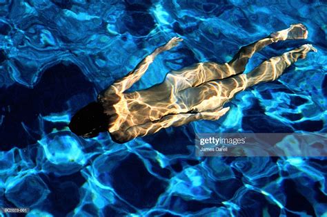 Young Naked Woman Swimming Underwater Overhead View High Res Stock