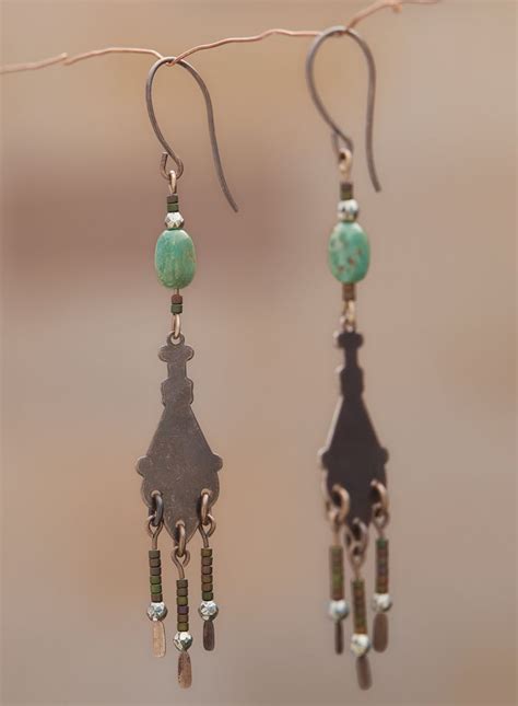 The Fringed Antiqued Brass Chandelier Earrings Are Topped With