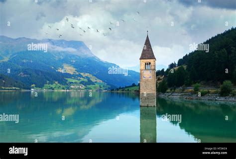 Beautiful View Of The Lake Resia Famous Tower In The Water Alps