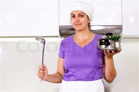 female cook in her kitchen stock image colourbox