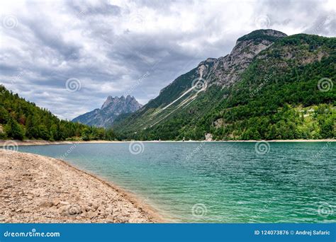Alpine Glacier Lake With Turquoise Water And Mountains In Background