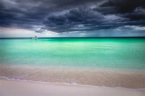 Tropical Caribbean Beach With Storm Clouds In Montego Bay Jamaica