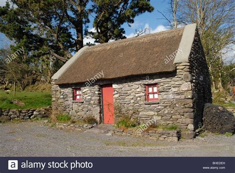 Traditional Irish Stone Cottage With A Thatched Roof In County Cork