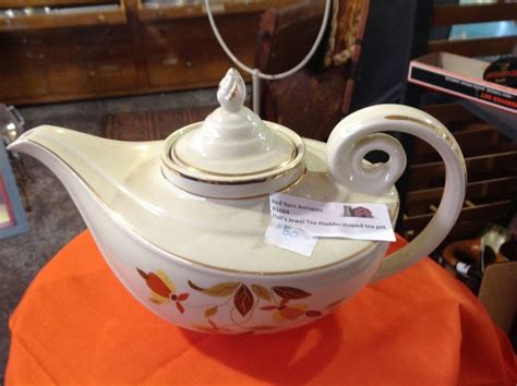 A White Tea Pot With A Tag On It