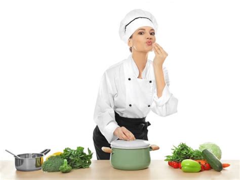 Young Female Chef Cooking In Kitchen — Stock Photo © Belchonock 163667384
