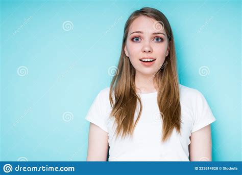 A Cheerful Girl In A White T Shirt Is Surprised And Happy While