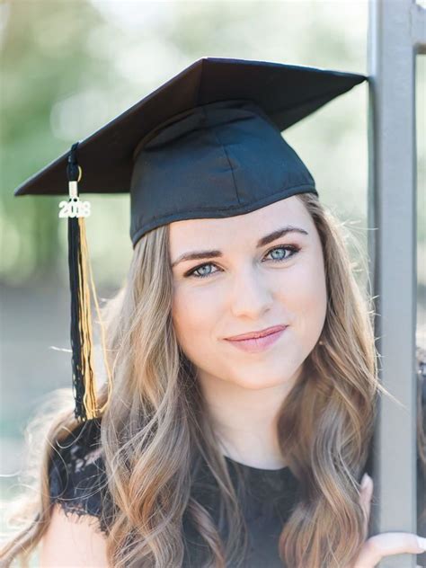 A Woman Wearing A Graduation Cap And Gown