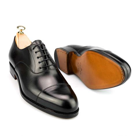 An oxford shoe is characterized by shoelace eyelets tabs that are attached under the vamp, a feature termed closed lacing. LACE-UP OXFORDS TOE-CAP SHOES IN BLACK CALF | CARMINA